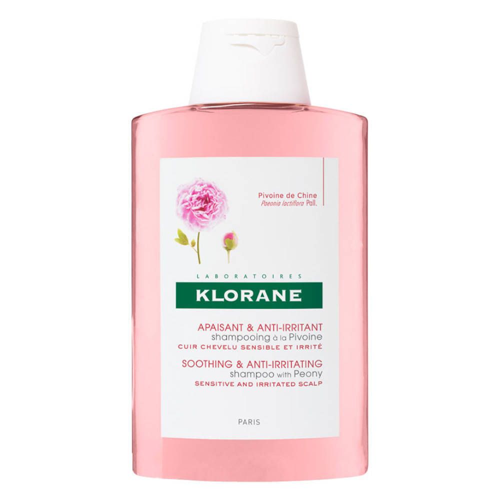 Flacon de shampooing rose avec bouchon blanc. Étiquette avec logo, nom du produit et illustration de pivoine. Texte en allemand et anglais.
