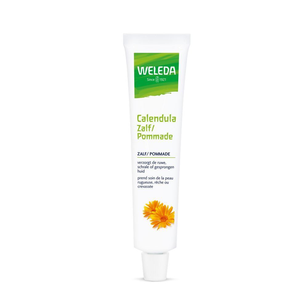 Tube blanche Weleda Calendula Pommade. Logo vert. Inscription du nom du produit. Deux fleurs jaunes en bas.