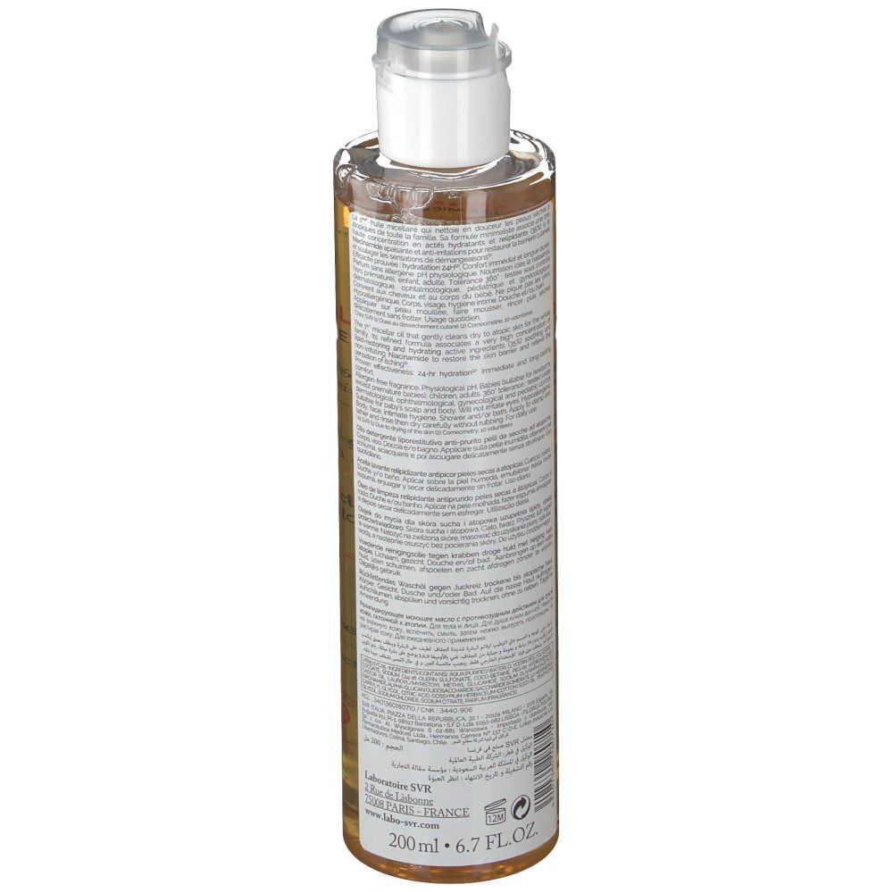 Dos du flacon. Flacon transparent avec liquide ambré. Bouchon blanc. Étiquette avec texte.