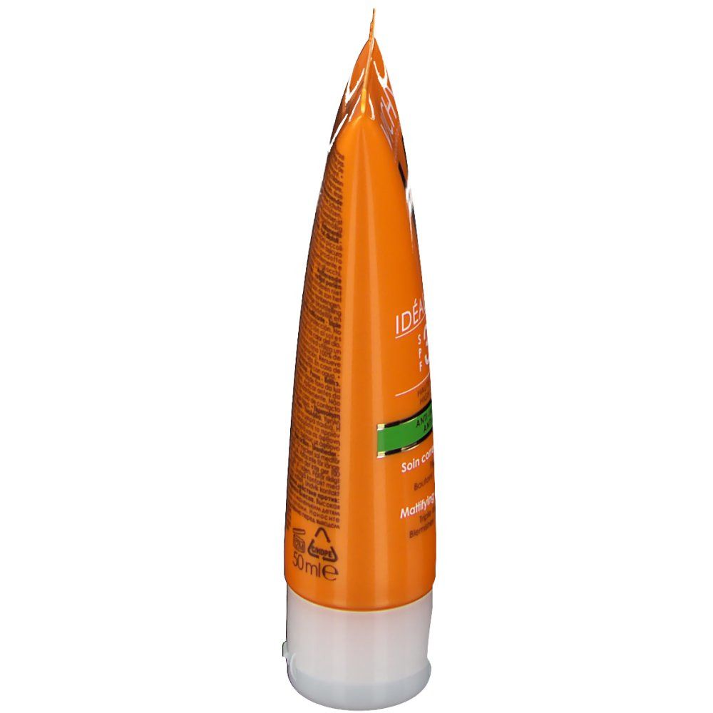 Tube orange. Texte: Ideal Soleil, SPF 30, Anti-imperfections. Bouchon blanc. Accents verts.