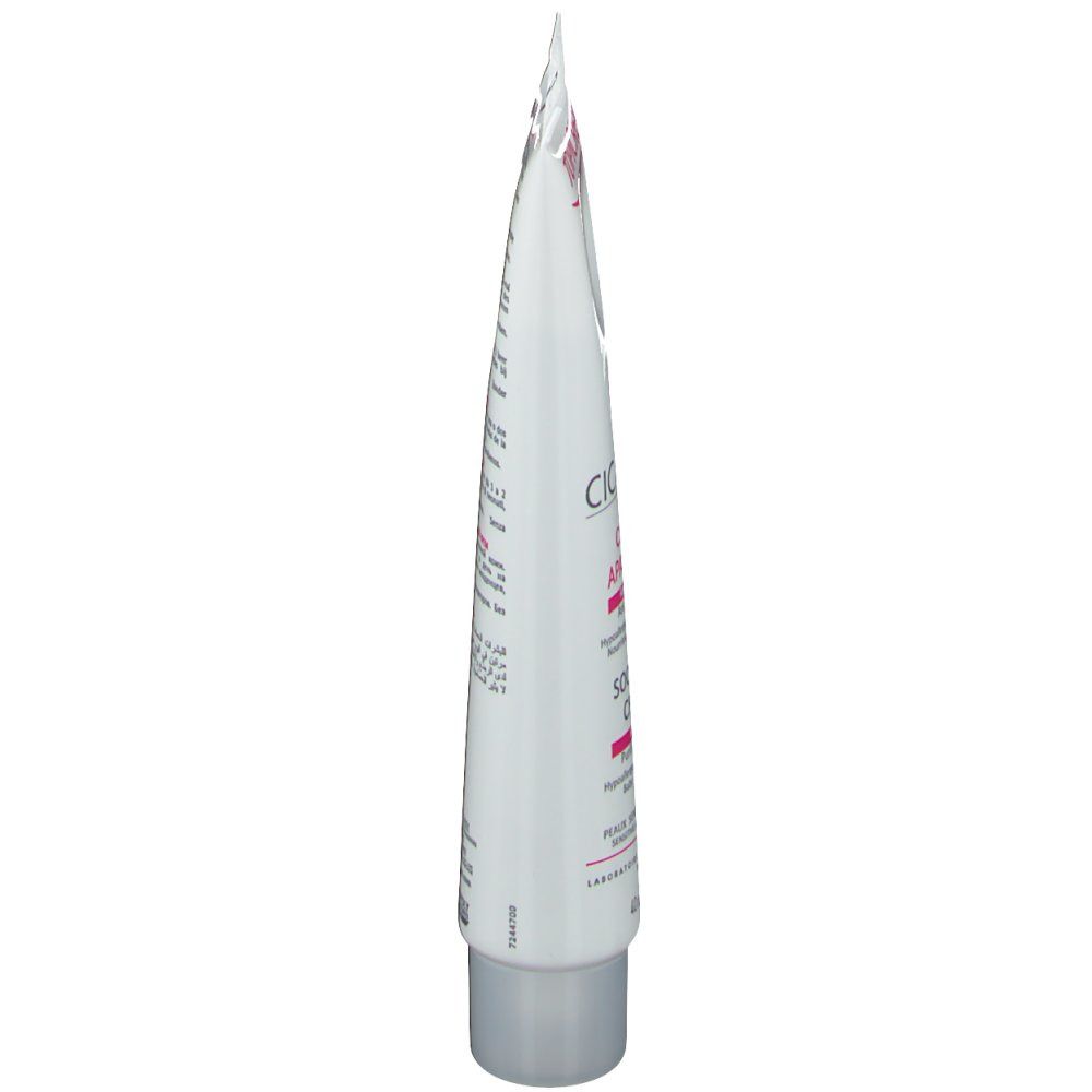 Vue latérale d'un tube blanc avec détails roses et gris. Texte en plusieurs langues.