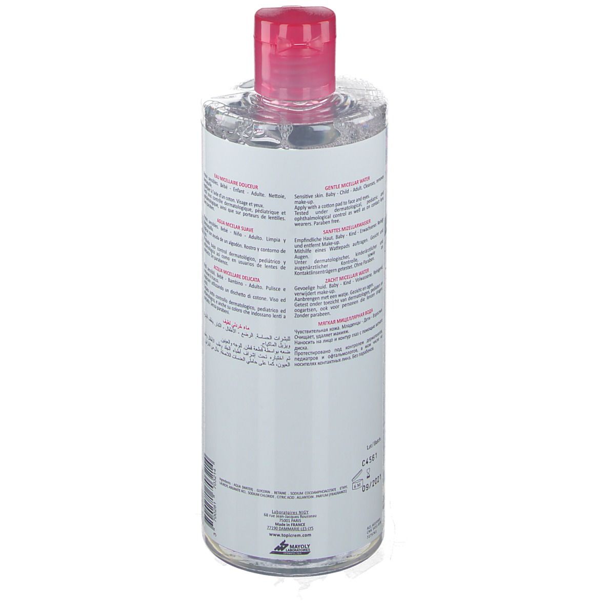 Flacon transparent, bouchon rose. Étiquette avec texte multilingue. Produit pour peaux sensibles.
