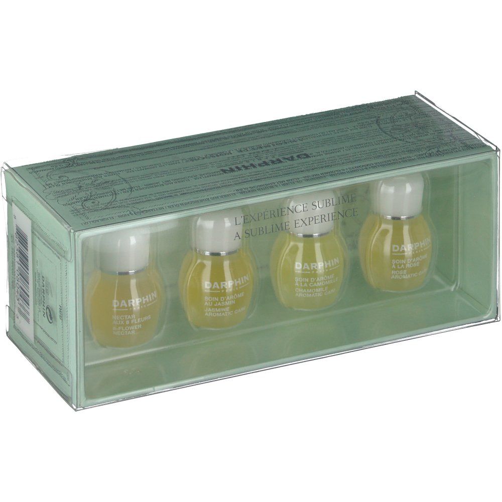 Coffret avec quatre petites bouteilles dans une boîte transparente. Chaque bouteille porte la marque "DARPHIN".