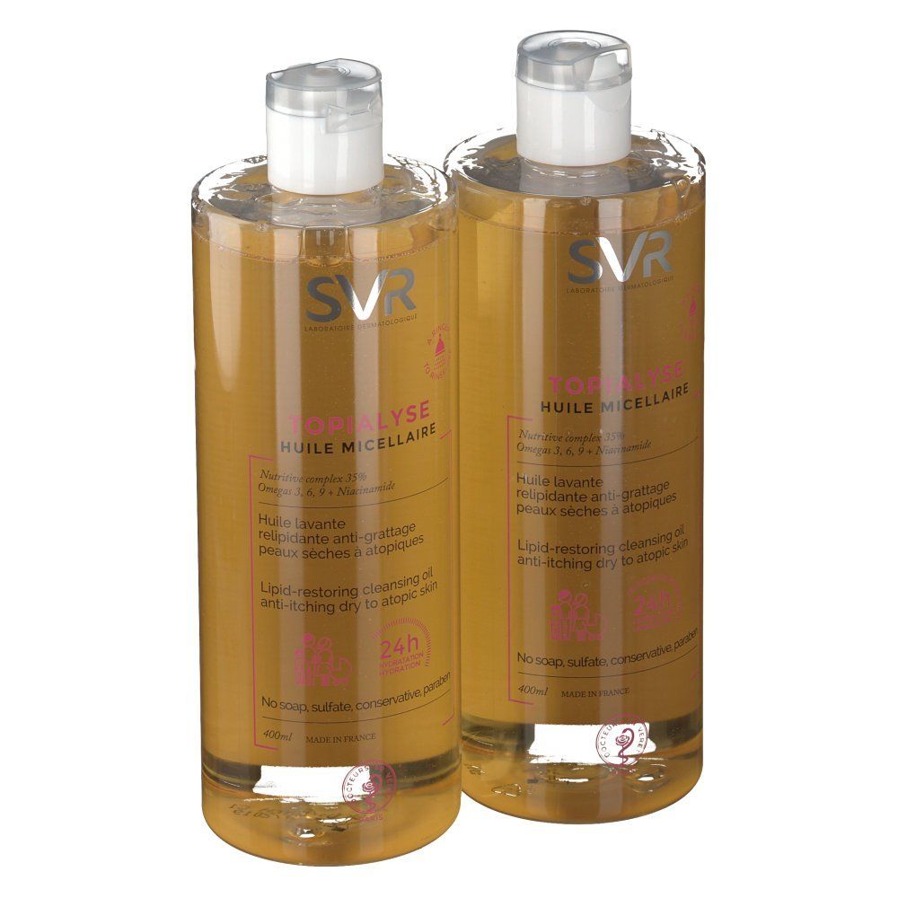 Deux flacons de SVR Topialyse Huile Micellaire. Liquide clair, bouchon blanc, étiquette rose. Inscription: 24h.