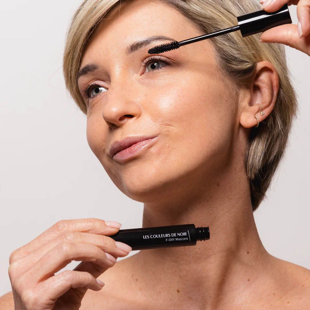 Vrouw brengt mascara aan. Les Couleurs de Noir Foxy Mascara.