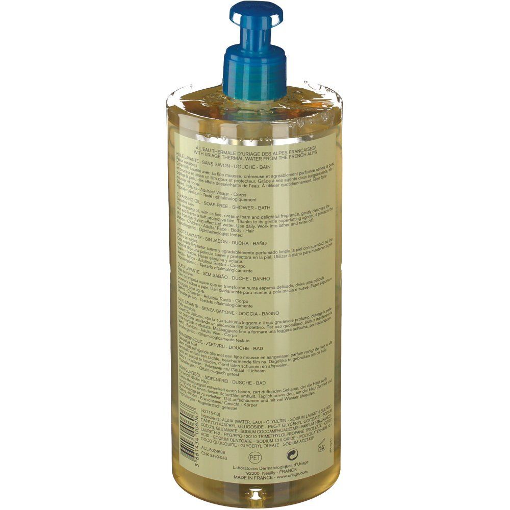 Dos du flacon d'Huile Lavante Uriage. Informations produit sur l'étiquette. Texte bleu et blanc, liquide transparent.