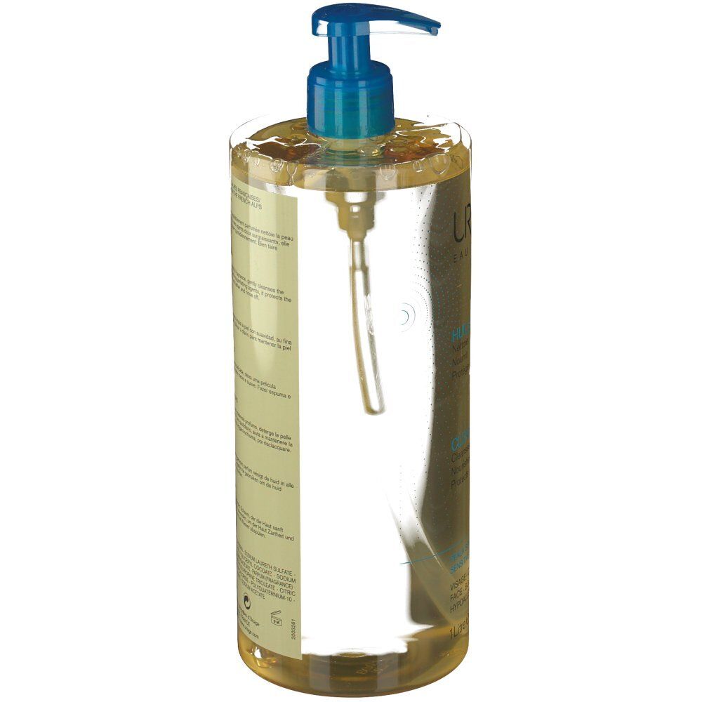 Dos du flacon d'Huile Lavante Uriage. Informations produit sur l'étiquette. Texte bleu et blanc, liquide transparent.