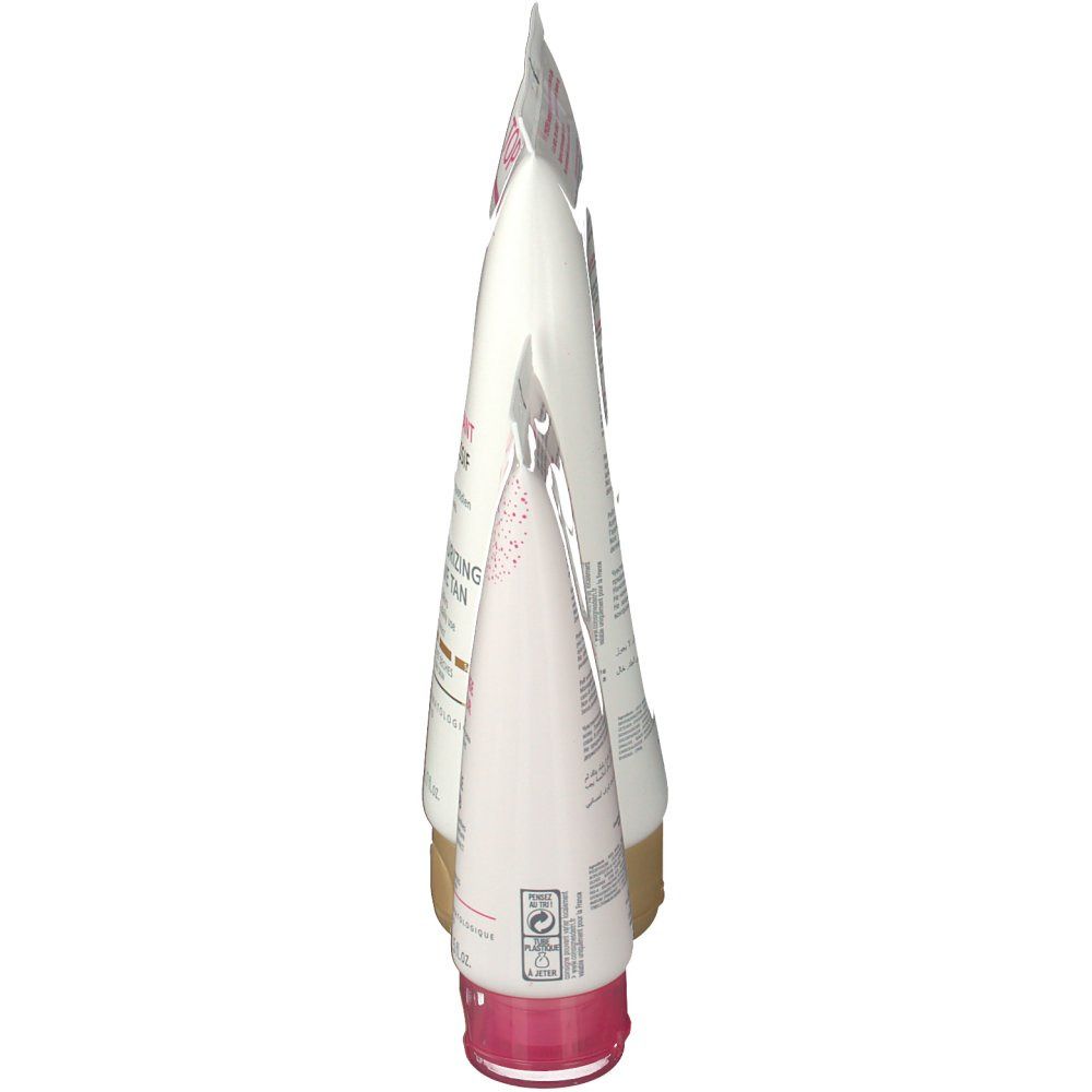 Zijaanzicht van twee tubes. Beide wit met roze en gouden accenten. De kleinere tube heeft een roze dop.