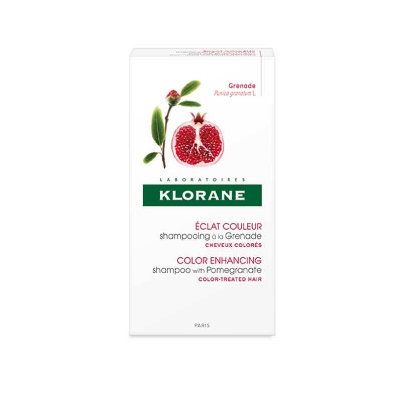 Emballage de shampooing Klorane. Blanc, avec illustration de grenade et informations produit. Texte : Éclat Couleur, Color Enhancing.