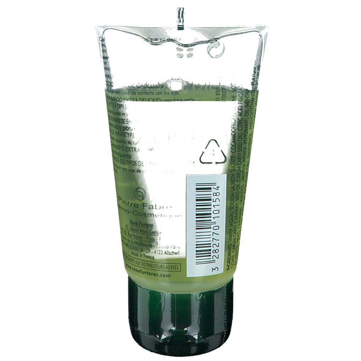 Tube transparent avec contenu vert. Bouchon noir. Code-barres et texte sur étiquette blanche. Nom du produit illisible.