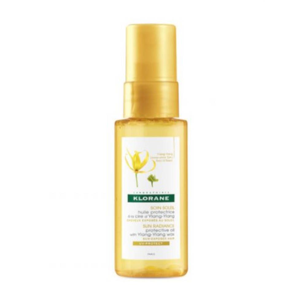 Klorane huile protectrice avec cire d'Ylang-Ylang. Flacon jaune avec vaporisateur. Étiquette avec logo et texte.