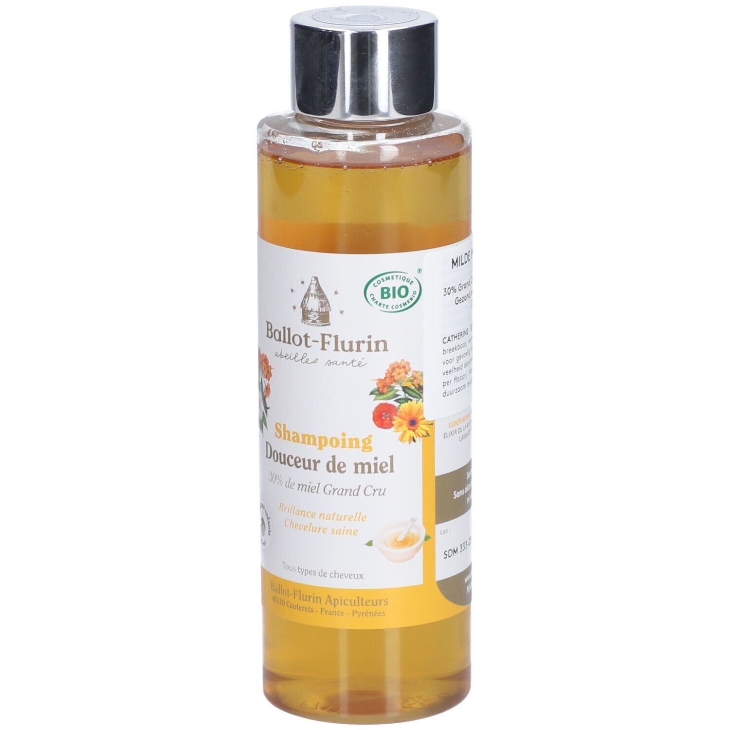 Shampoo-Flasche mit Honig. Etikett mit floralen Motiven und Text. Bio-Zertifizierung. Silberner Deckel.