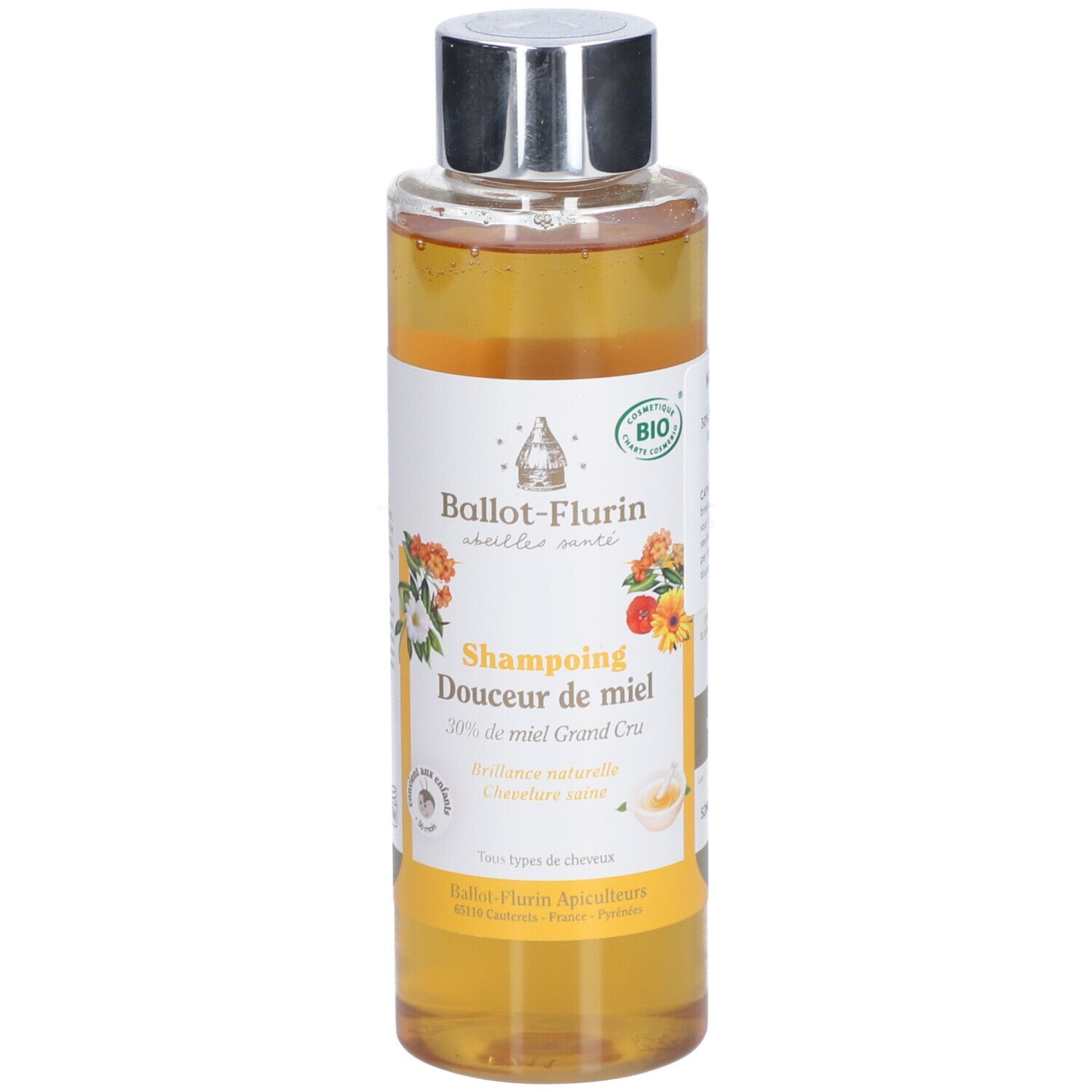Shampoo-Flasche mit Honig. Etikett mit floralen Motiven und Text. Bio-Zertifizierung. Silberner Deckel.