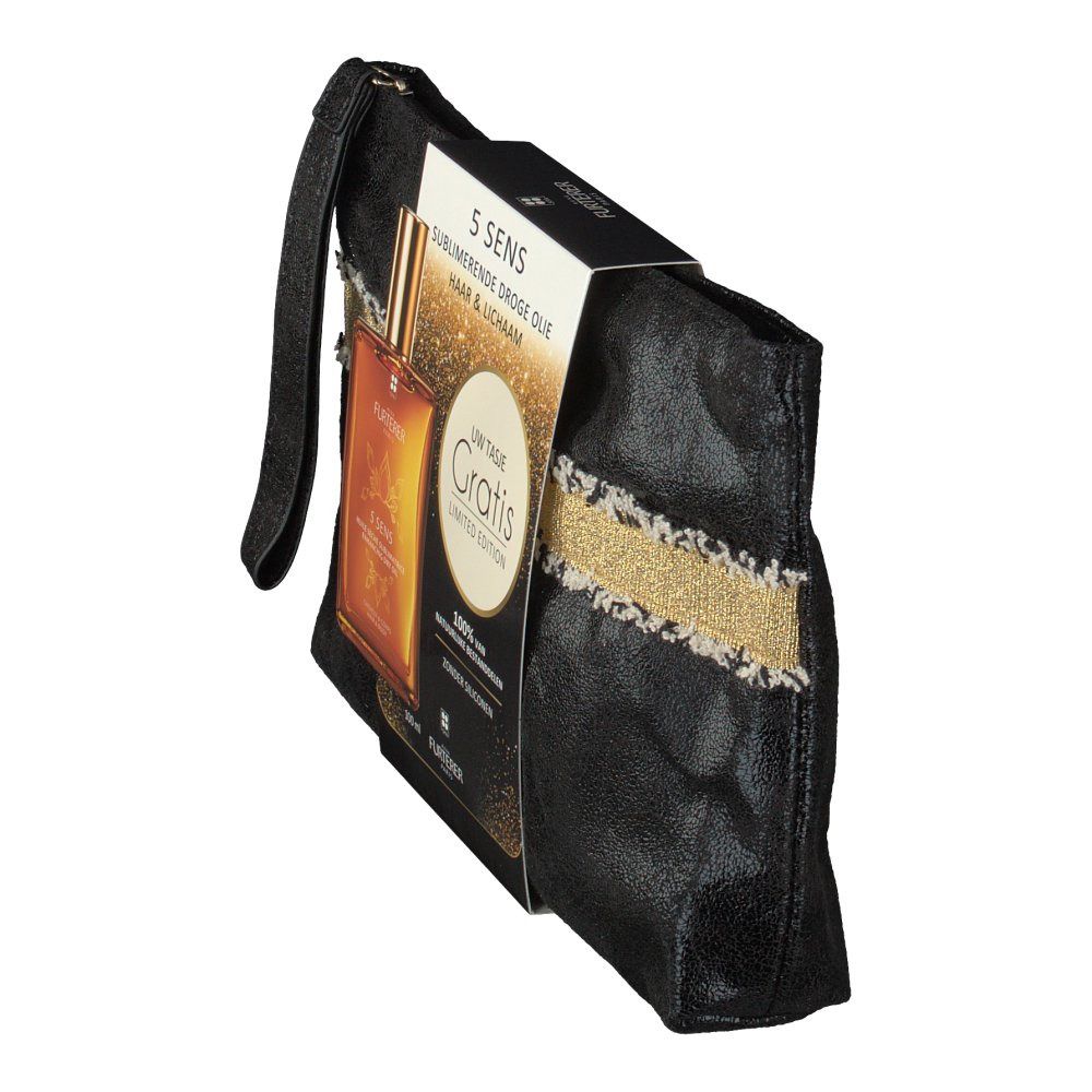 Trousse de toilette noire avec bande dorée et flacon d'huile sèche. Emballage avec nom du produit et texte. Trousse avec poignée.