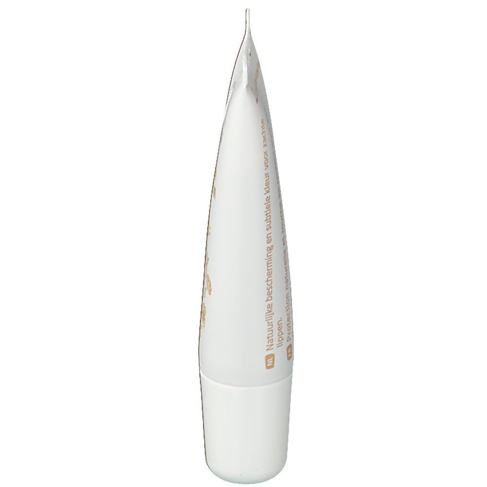 Baume à lèvres Weleda Nude. Tube blanc avec accents bruns. Texte: Natuurlijke bescherming en subtiele kleur voor lippen.