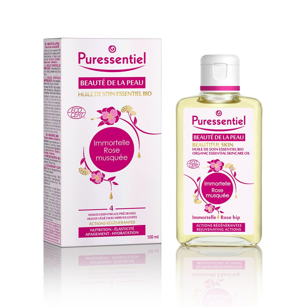 Product met verpakking. Huidverzorgingsolie in vierkante fles en doos. Labels met productnaam, ingrediënten en certificering.