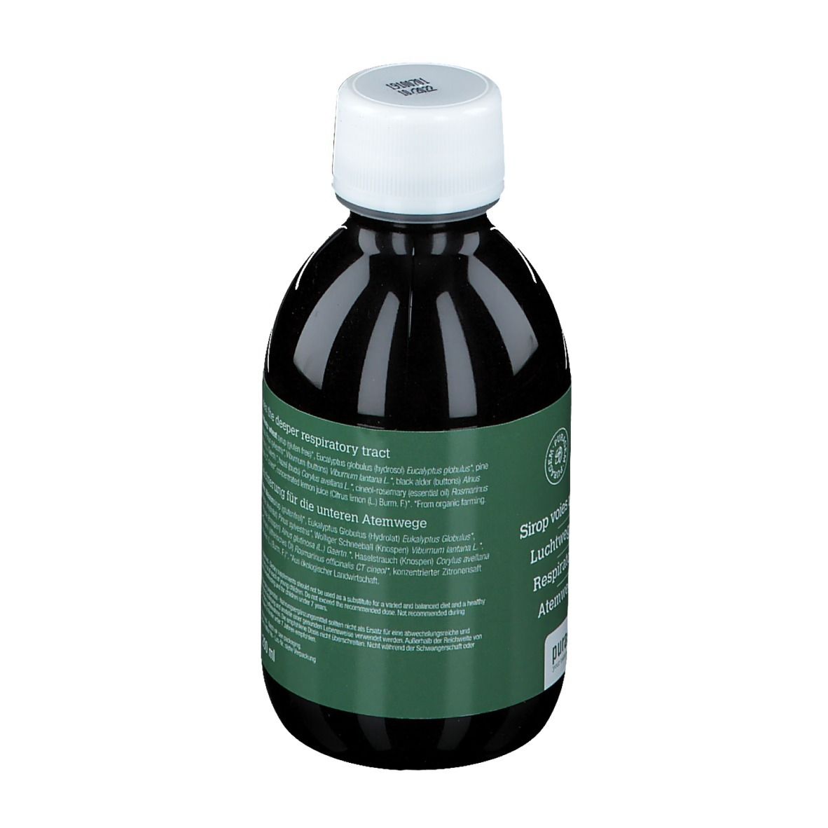 Dos d'une bouteille de liquide brun. Étiquette multilingue.