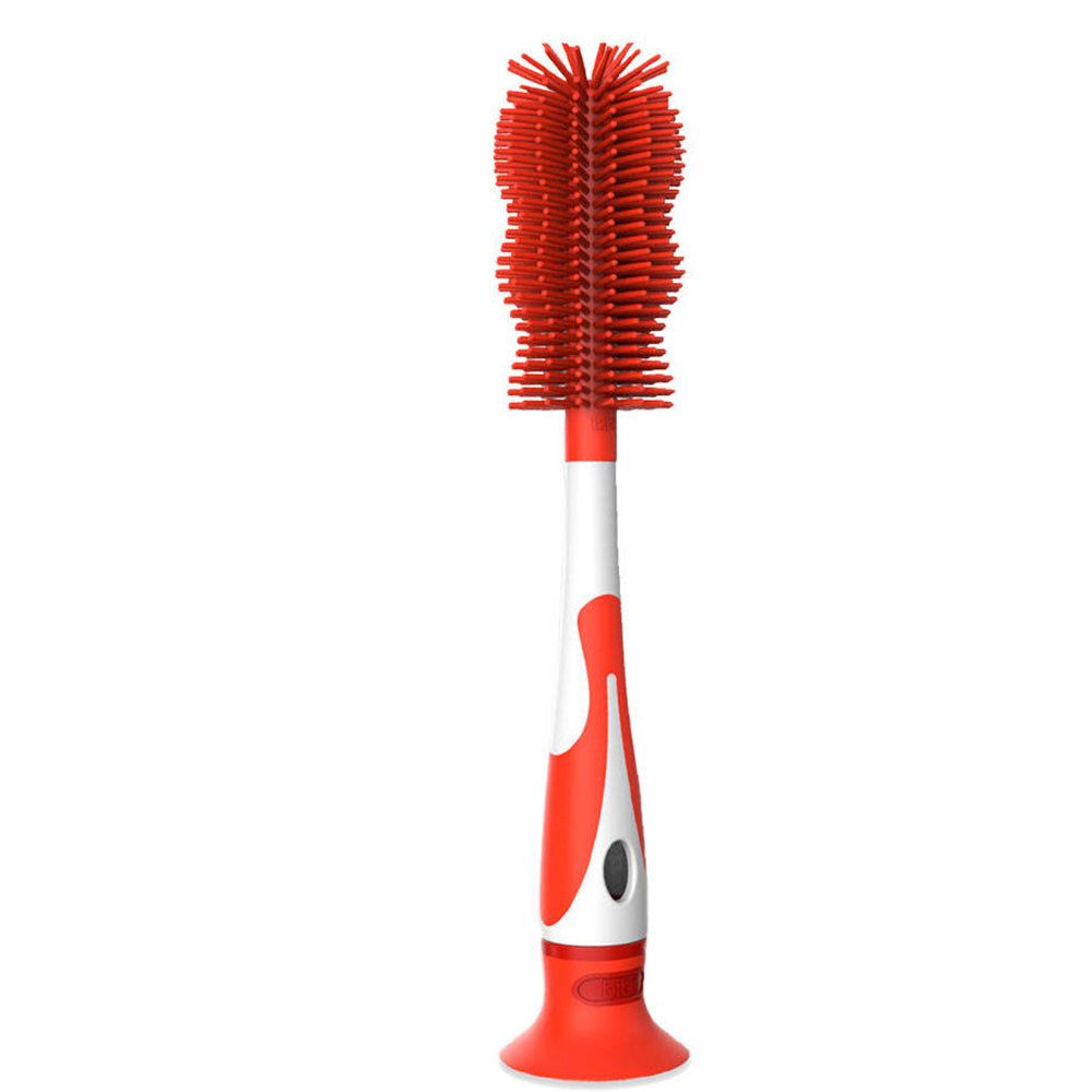 Brosse à biberon avec tête rouge et manche. La poignée est rouge et blanche, avec une ventouse.
