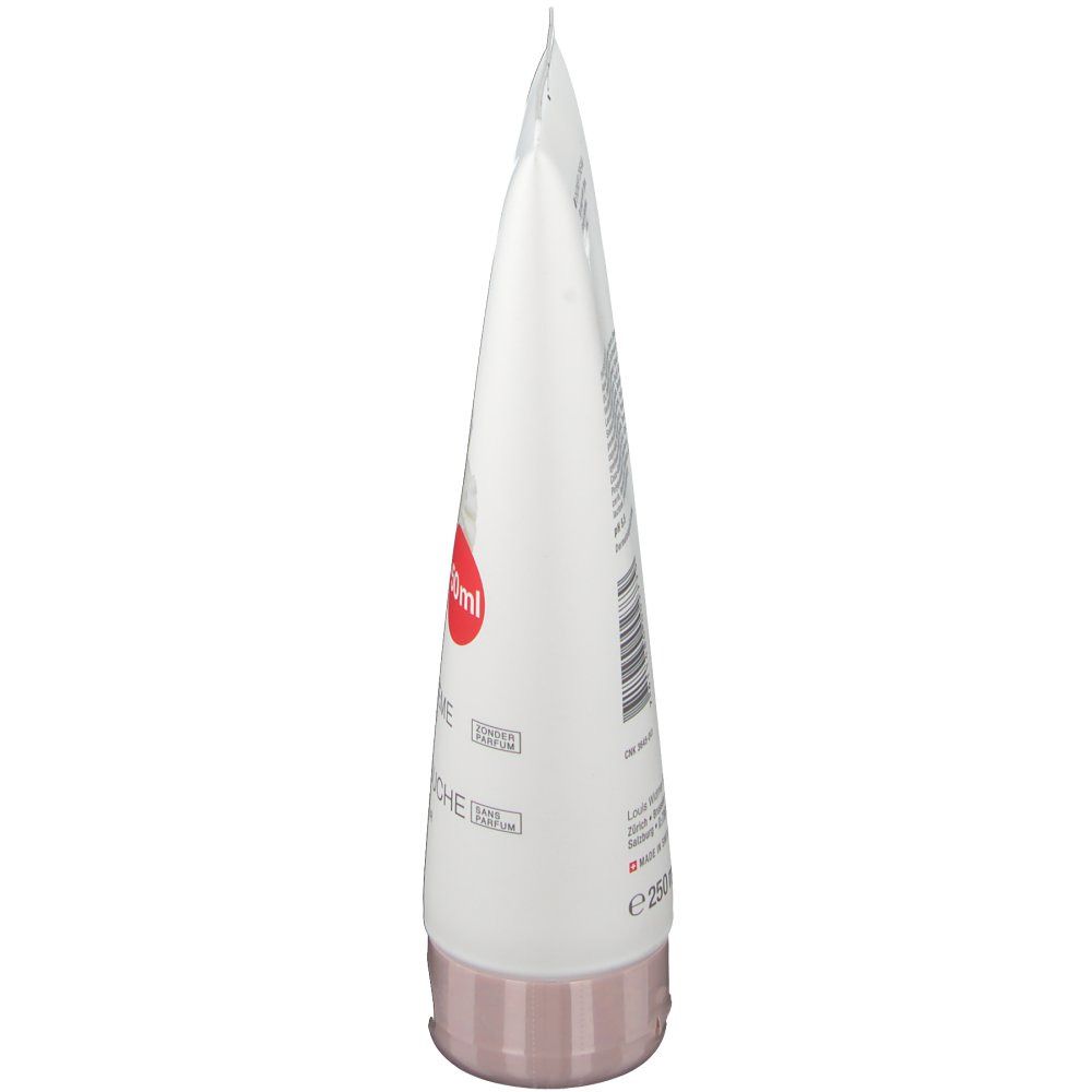 Tube blanche avec bouchon rose. Autocollant rouge avec texte. Nom du produit et autres informations imprimées.
