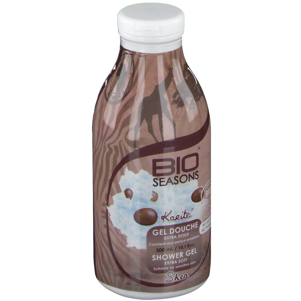 Flacon marron avec bouchon blanc. Inscription: Bio Seasons, Karité, Gel Douche, 300 ml. Illustration: girafe, beurre de karité.