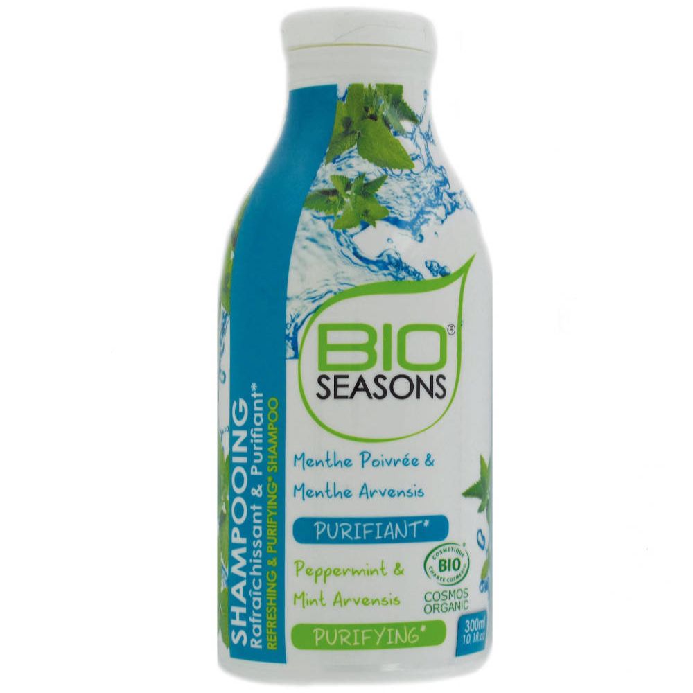 Flacon de shampooing Bio Seasons. Bouchon blanc, flacon bleu et blanc avec logo et texte. Contient de la menthe. Certification bio.