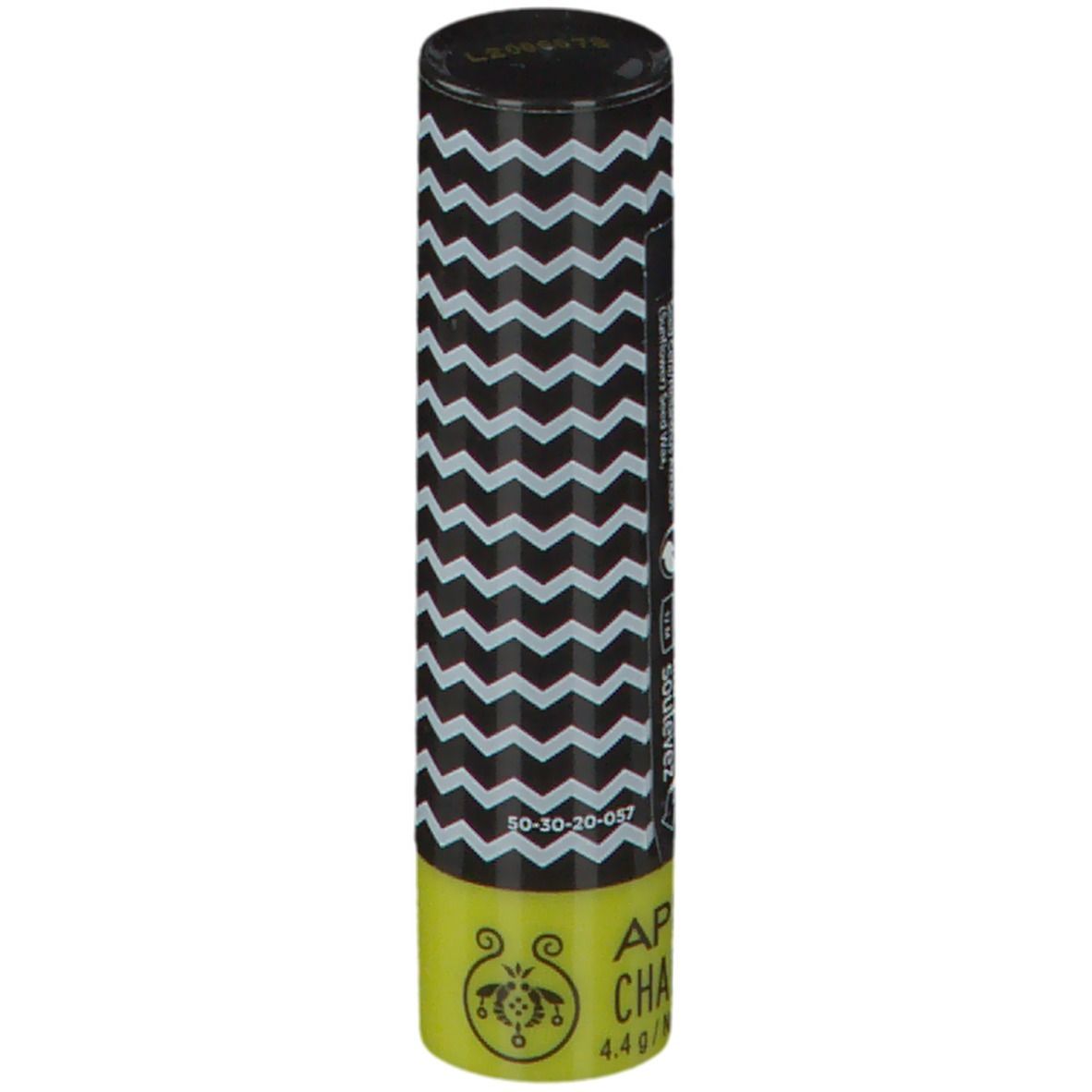 Lippenpflegestift mit schwarz-weißem Zickzackmuster. Gelber Bereich mit Produktnamen und Logo. Schwarzer Deckel.