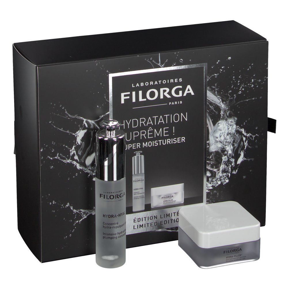 Geschenkset mit Filorga-Produkten. Enthält eine Flasche, einen Tiegel und eine kleine Packung. Schwarzer Hintergrund mit Wasserspritzern.
