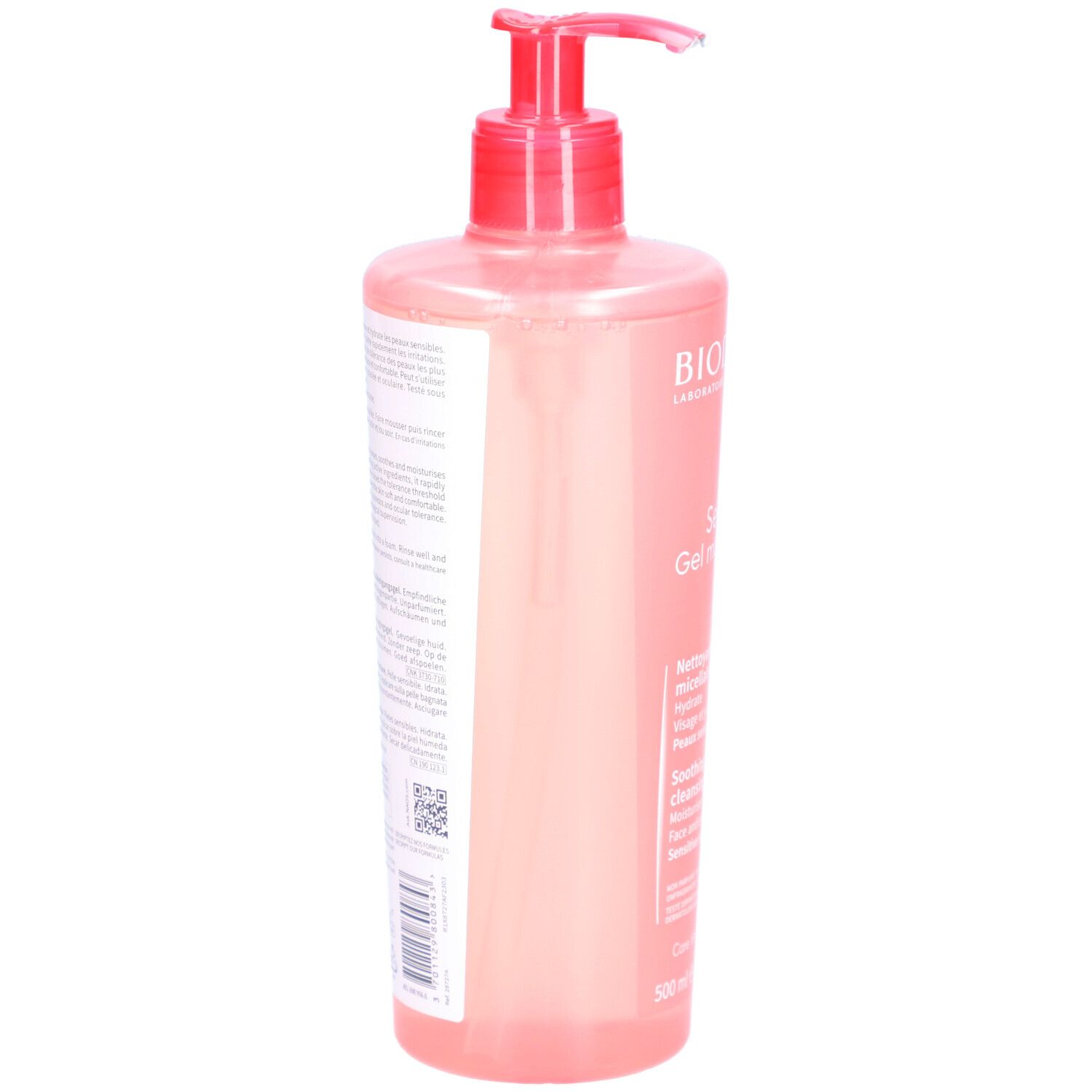 Retro di un flacone rosa con dosatore. Testo in più lingue. Codice a barre e altri simboli.