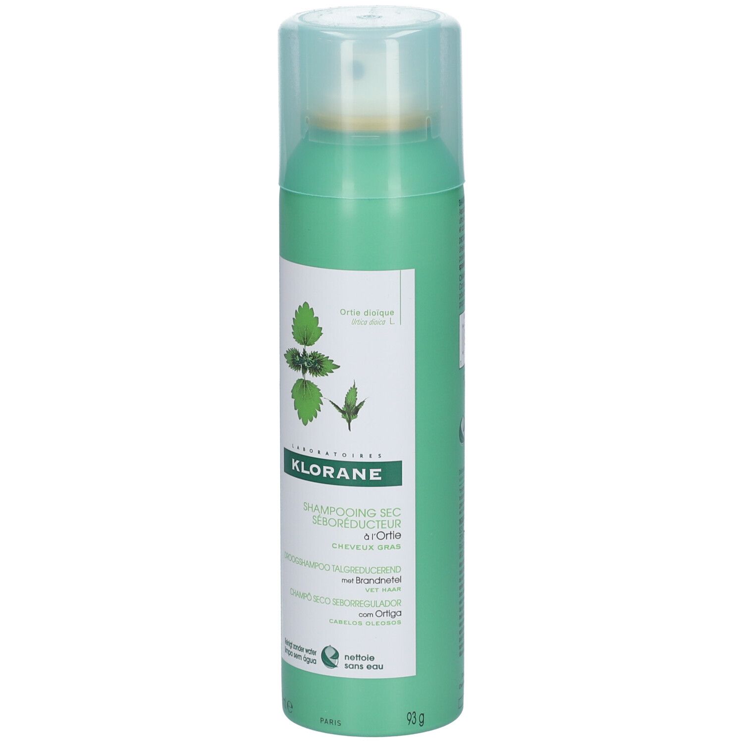 Flacon vert de shampooing sec. Étiquette avec illustration de plante et nom du produit.