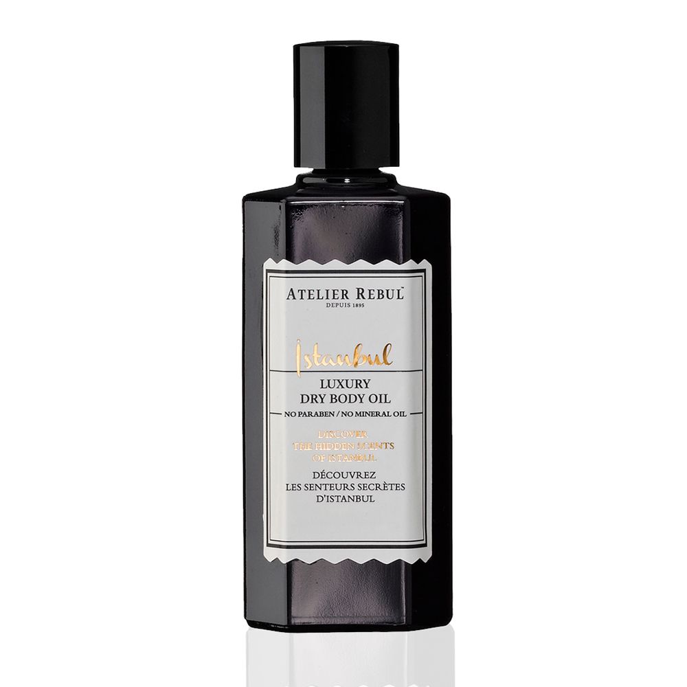 Zwarte fles met zwarte dop. Opschrift: ATELIER REBUL Istanbul Luxury Dry Body Oil.