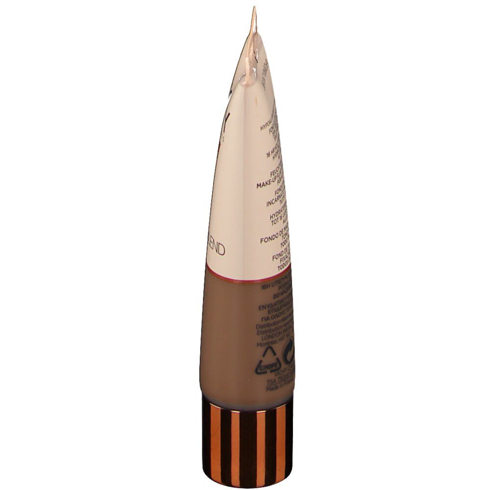 Tube de maquillage VICHY, vue latérale. Beige, marron et doré. Texte sur le côté du tube.