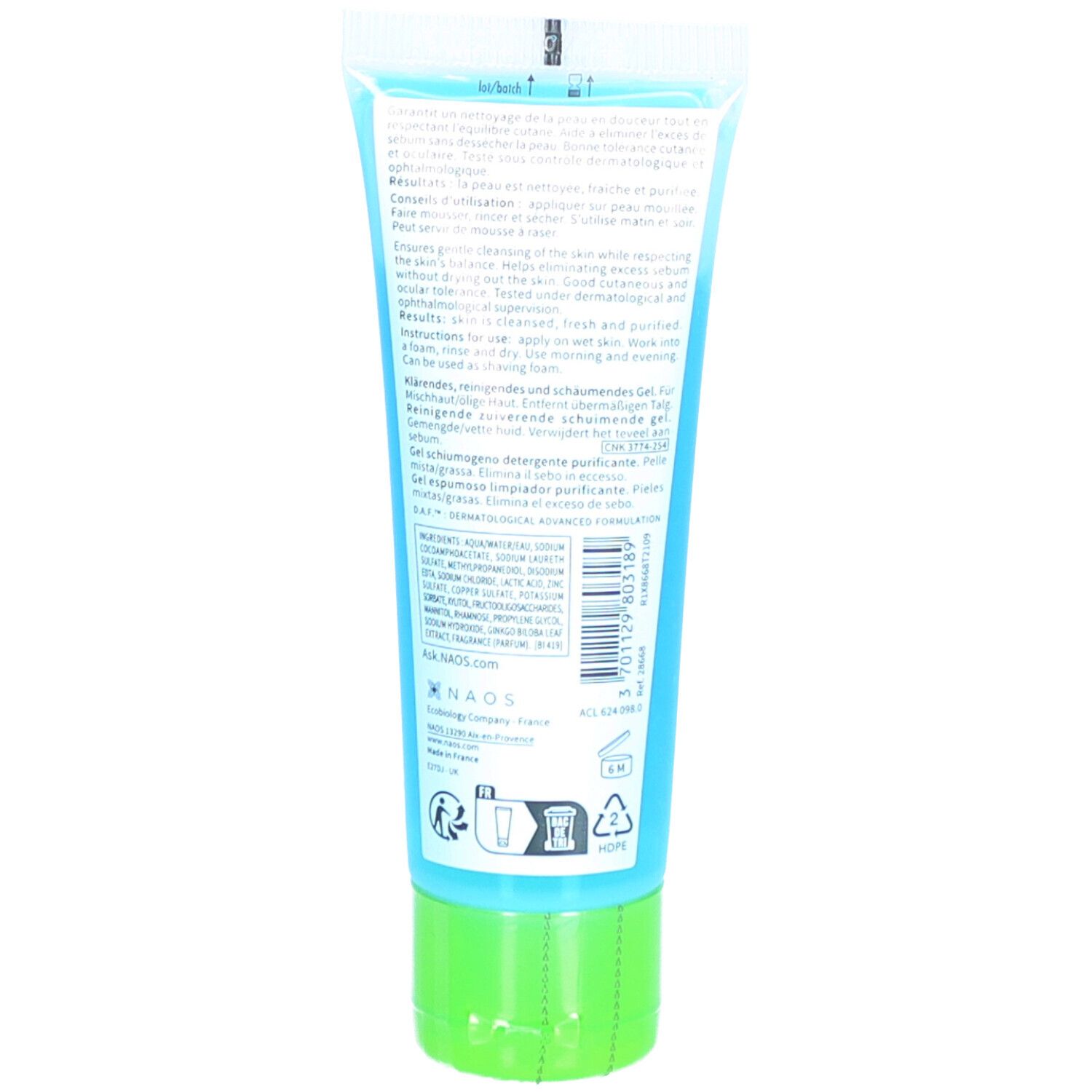 Achterkant van de tube. Tekst in meerdere talen. Groene dop. Blauw-transparante tube.
