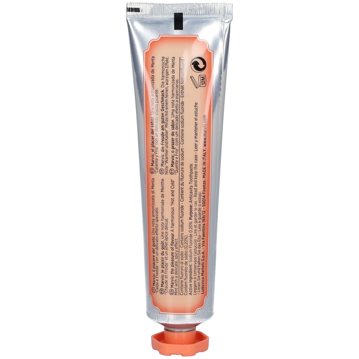 Achterkant van de tandpastatube. Tekst in meerdere talen. Oranje etiket. Zilveren tube met oranje dop.