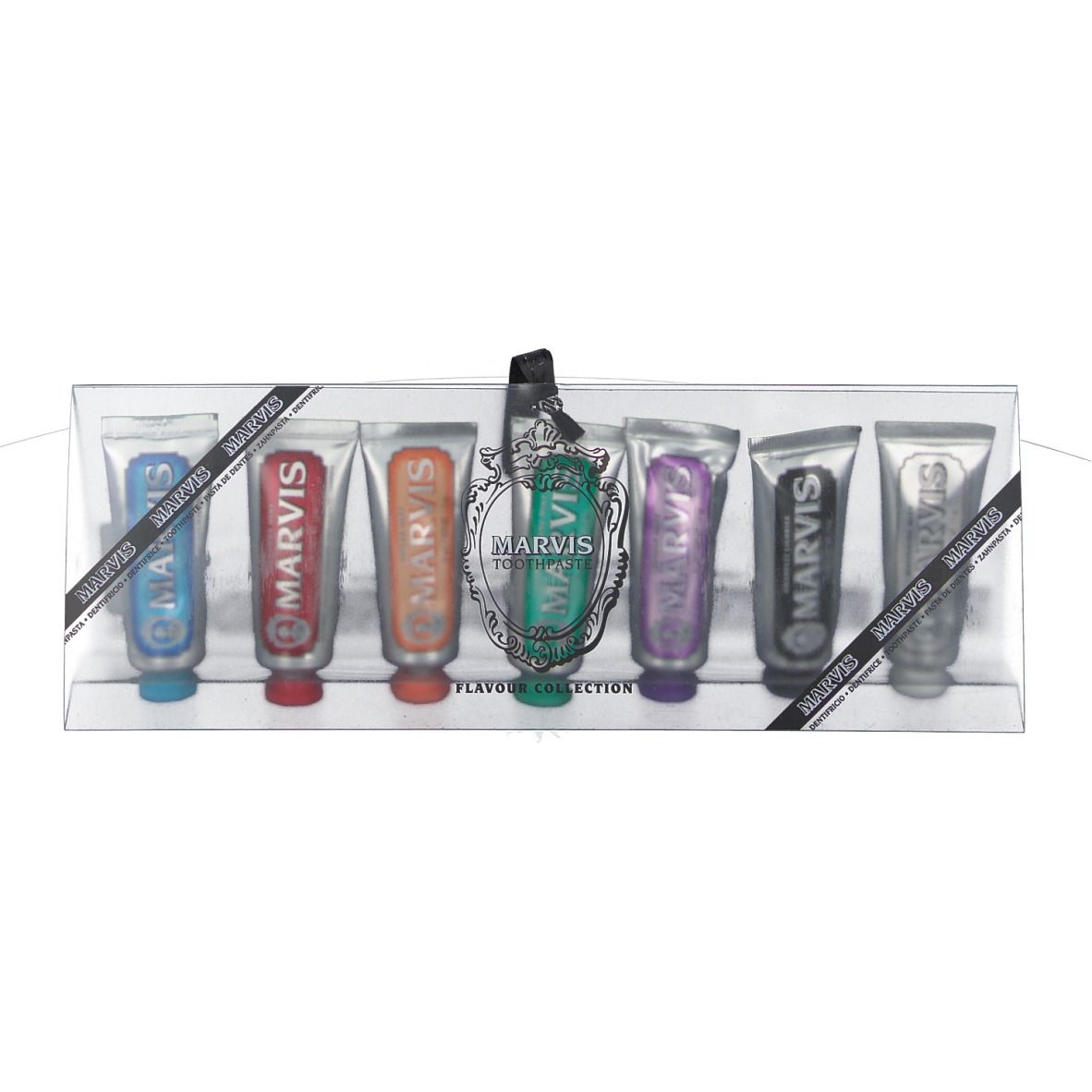 Zahnpasta-Set in transparenter Verpackung. Sieben Tuben in verschiedenen Farben. Schwarzes Band mit Logo.