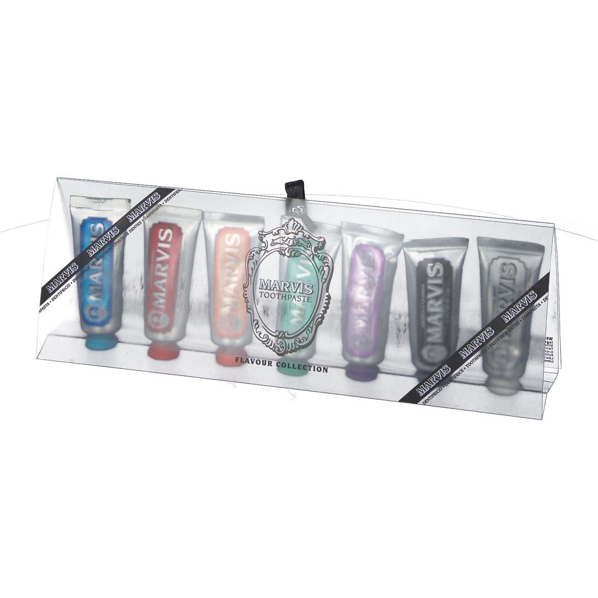 Zahnpasta-Set in transparenter Verpackung. Sieben Tuben in verschiedenen Farben. Schwarzes Band mit Logo.