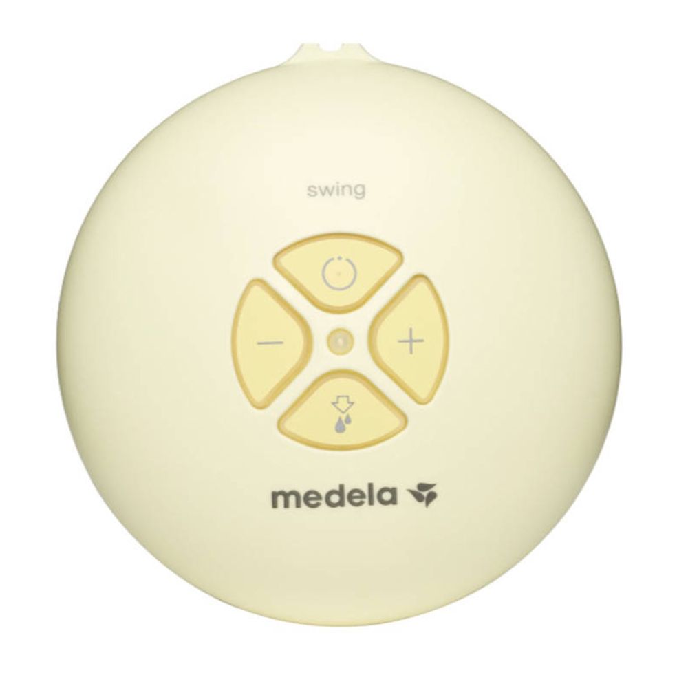 Moteur rond jaune du tire-lait avec boutons. Marque Medela, inscription 'swing'.