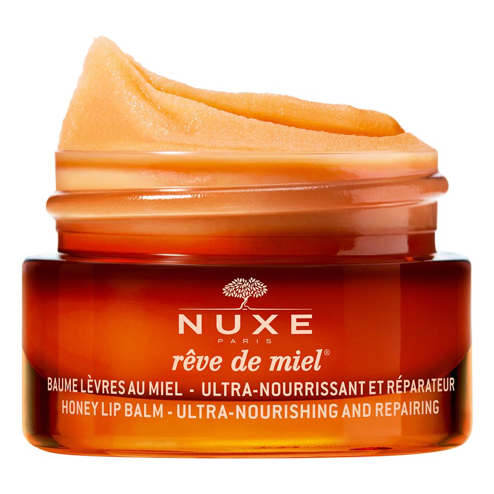 Pot de Baume Lèvres au Miel Nuxe ouvert. Baume couleur miel visible. Nom du produit et texte sur l'étiquette.