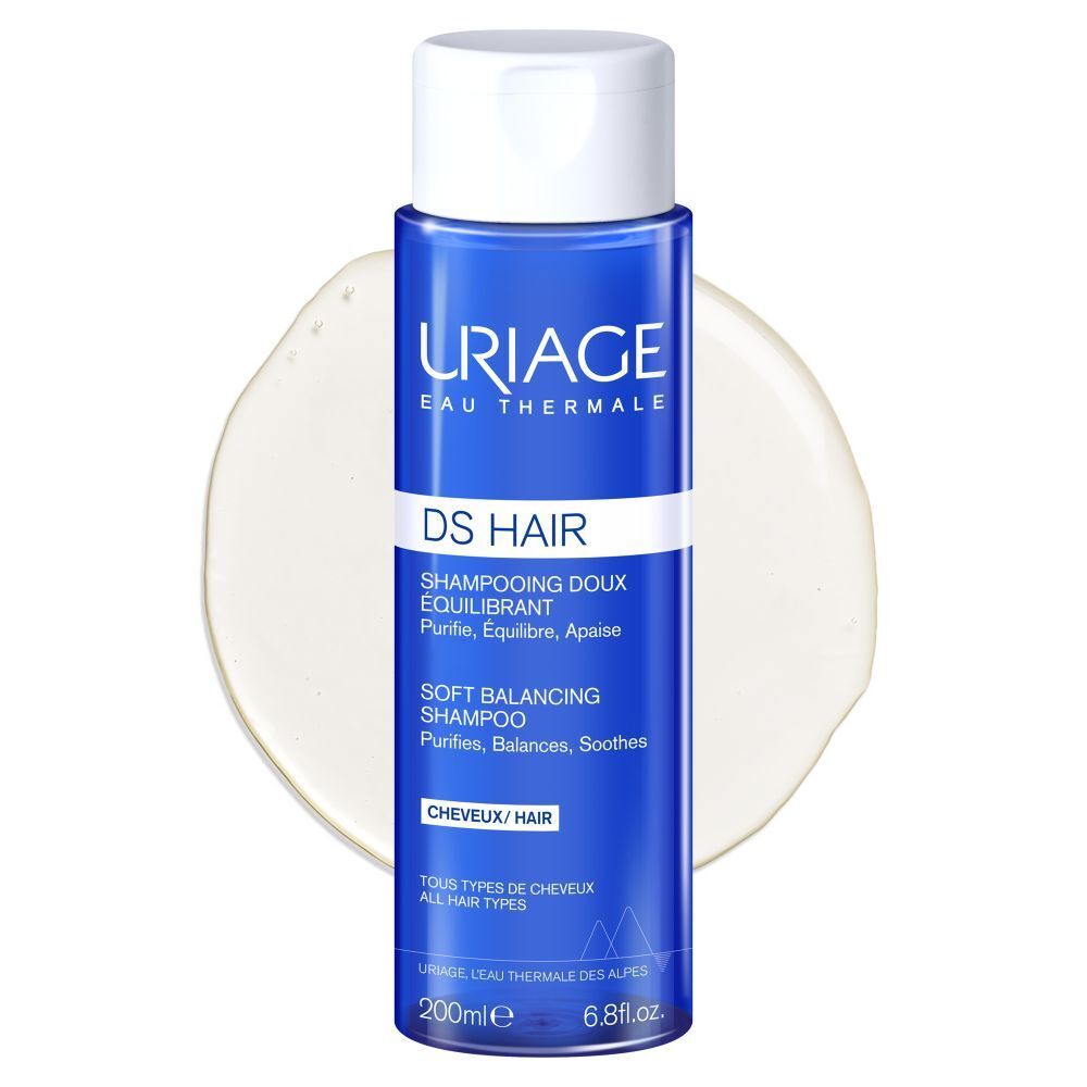 Achterkant van de Uriage DS Hair shampoo fles. Blauwe fles met witte dop. Tekst.