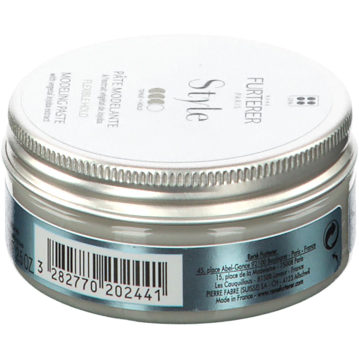 Ronde pot met zilveren deksel. Opschrift: FURTERER Style. Bevat modelleerpasta met jojoba-extract. Barcode en adres.