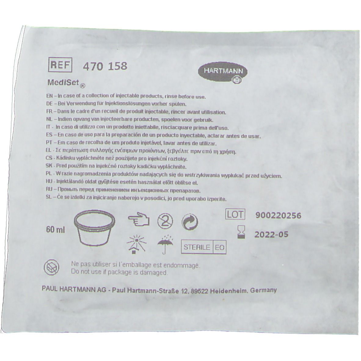 Verpackung mit Text und Logo. Produktinformationen, Chargennummer und Ablaufdatum.