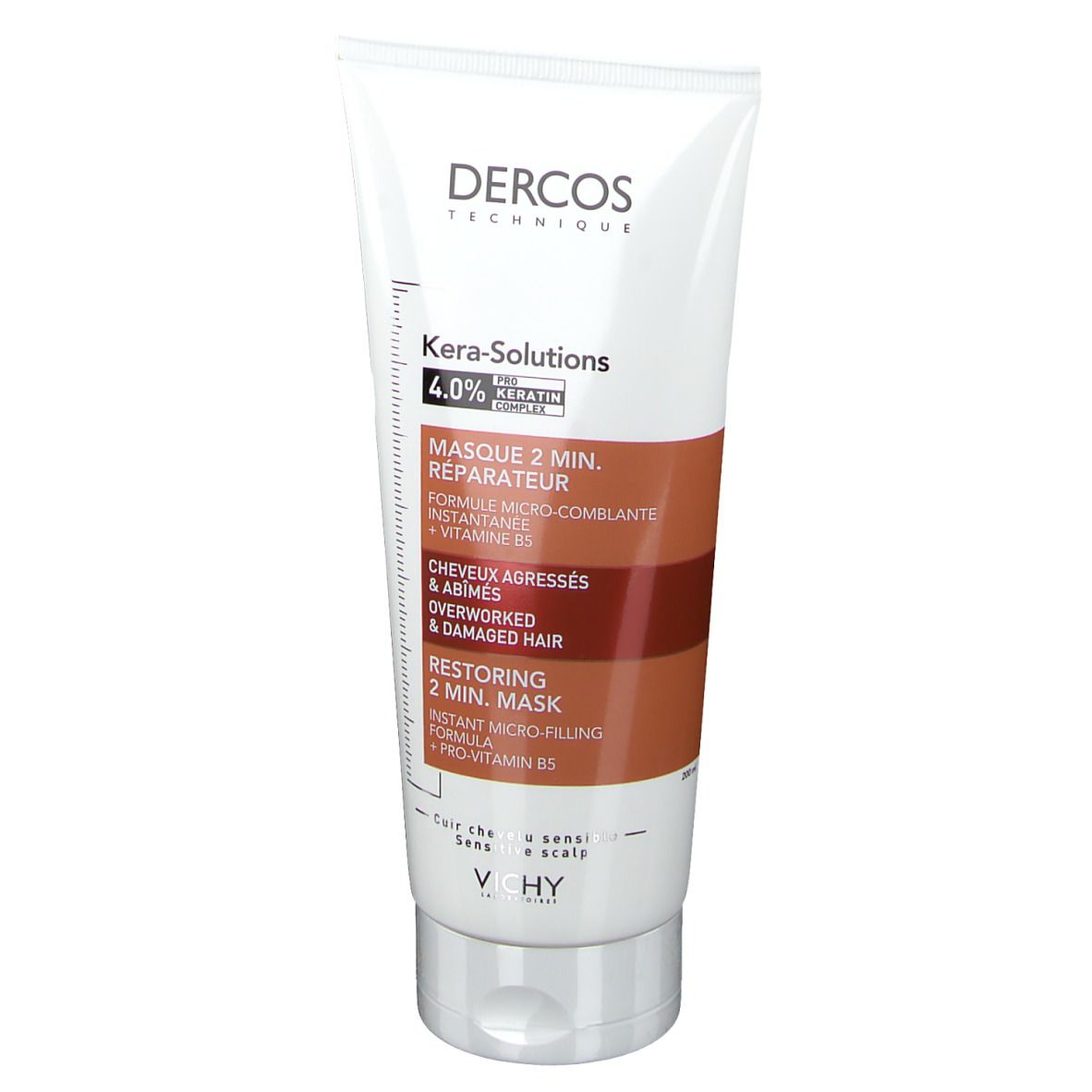 Tube blanc. Inscriptions: Dercos, Kera-Solutions, Masque 2 min. réparateur. Accents marron et rouge.