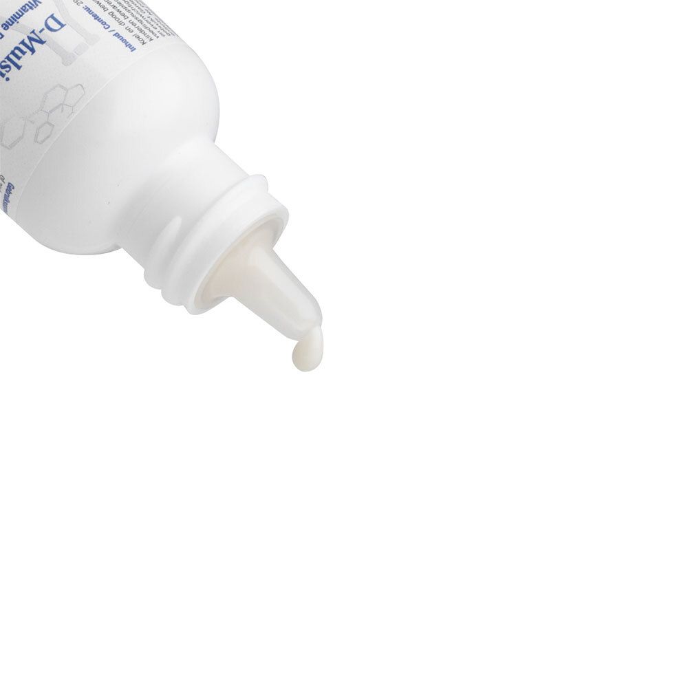 Gros plan du compte-gouttes. Une goutte de liquide sort du compte-gouttes.