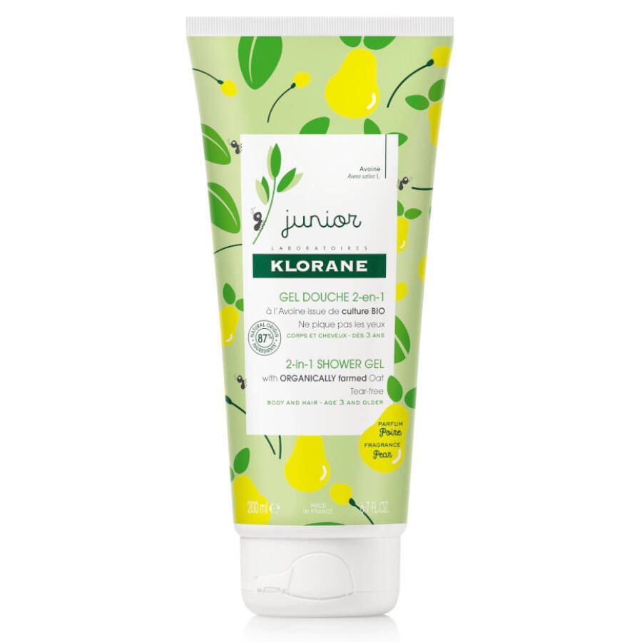 Tube de gel douche Klorane Junior 2-en-1. Design vert et jaune avec des poires. Texte: Junior, Klorane, Gel Douche 2-en-1, 2-in-1 Shower Gel. 87% ingrédients d'origine naturelle.