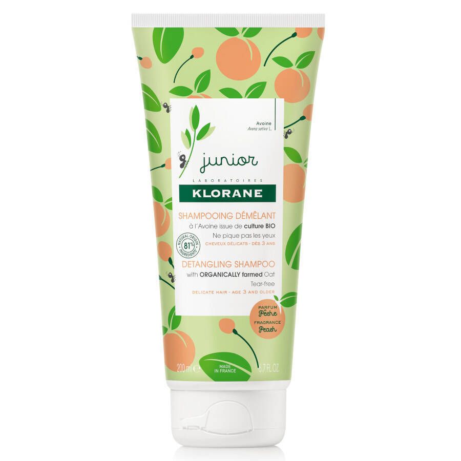 Shampoo-Tube mit Pfirsich-Dekor. Aufschrift 'KLORANE Junior'. Enthält 'Démêlant' und 'Detangling Shampoo'.