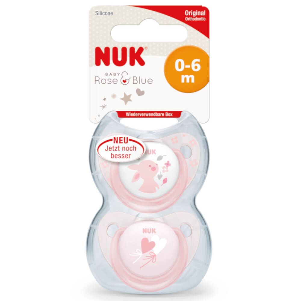 Emballage avec deux sucettes roses. Inscription : NUK, 0-6 m.