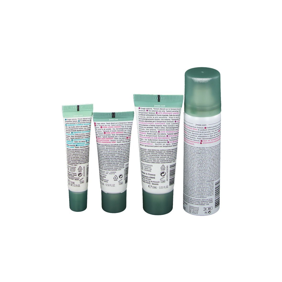 Dos de quatre tubes et une bouteille. Inscriptions et informations sur le contenu. Produits : lait, crème, concentré, brume.
