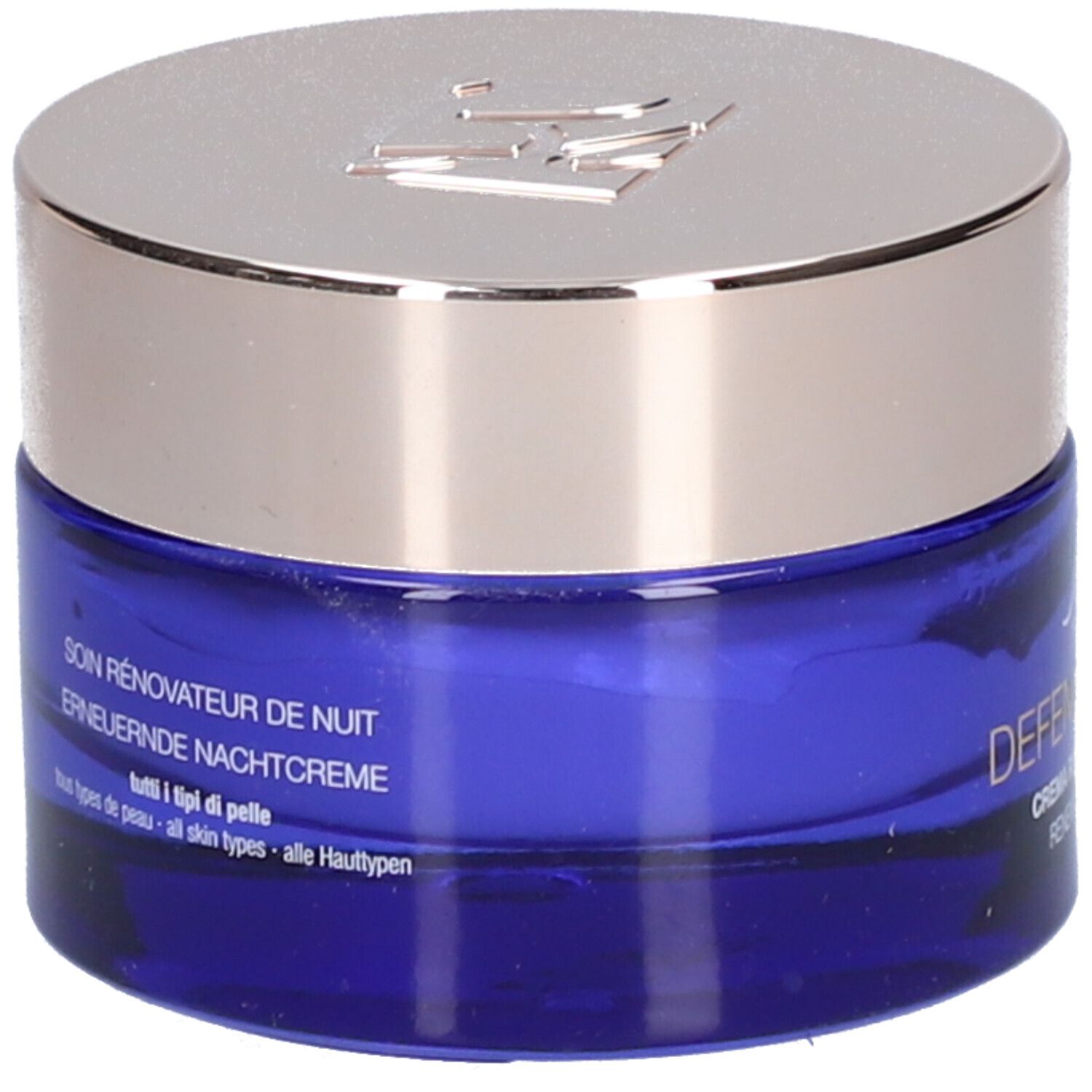 Blauwe crèmepot met zilveren deksel. Opschrift: Soin Rénovateur de Nuit, Erneuernde Nachtcreme. Voor alle huidtypes.