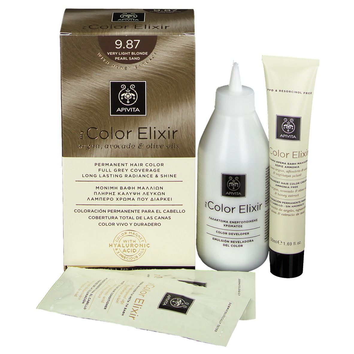 Kit de coloration capillaire. Comprend une boîte, une bouteille, un tube et trois sachets. Sur la boîte, on lit "9.87 Très blond perlé sable".