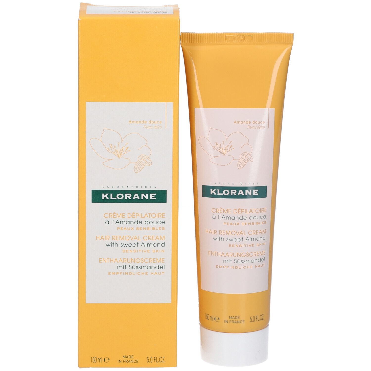 Gelbe Tube und Schachtel. Aufschrift: KLORANE, Crème dépilatoire à l'Amande douce, Hair Removal Cream, Enthaarungscreme mit Süßmandel. Verpackung.
