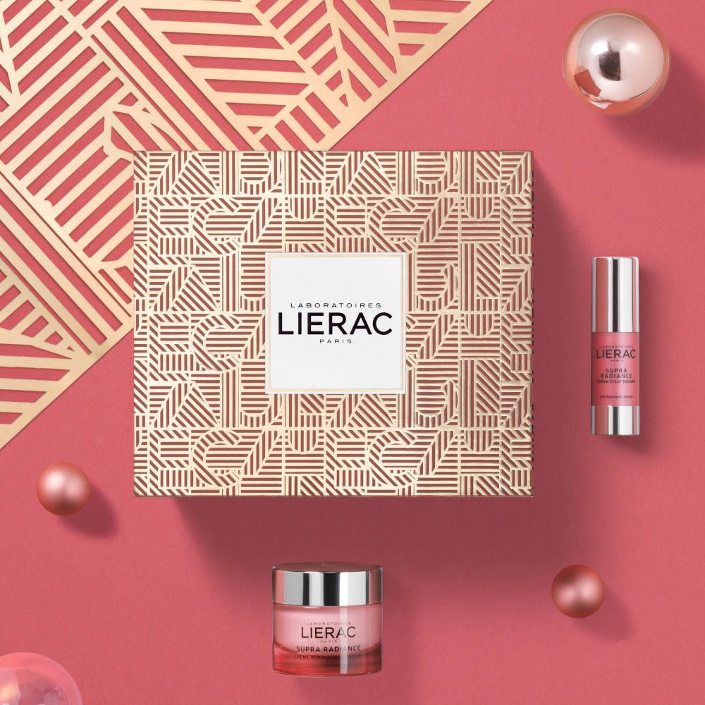 Coffret cadeau avec produits cosmétiques roses. Contient crème, sérum et emballage avec logo et texte.